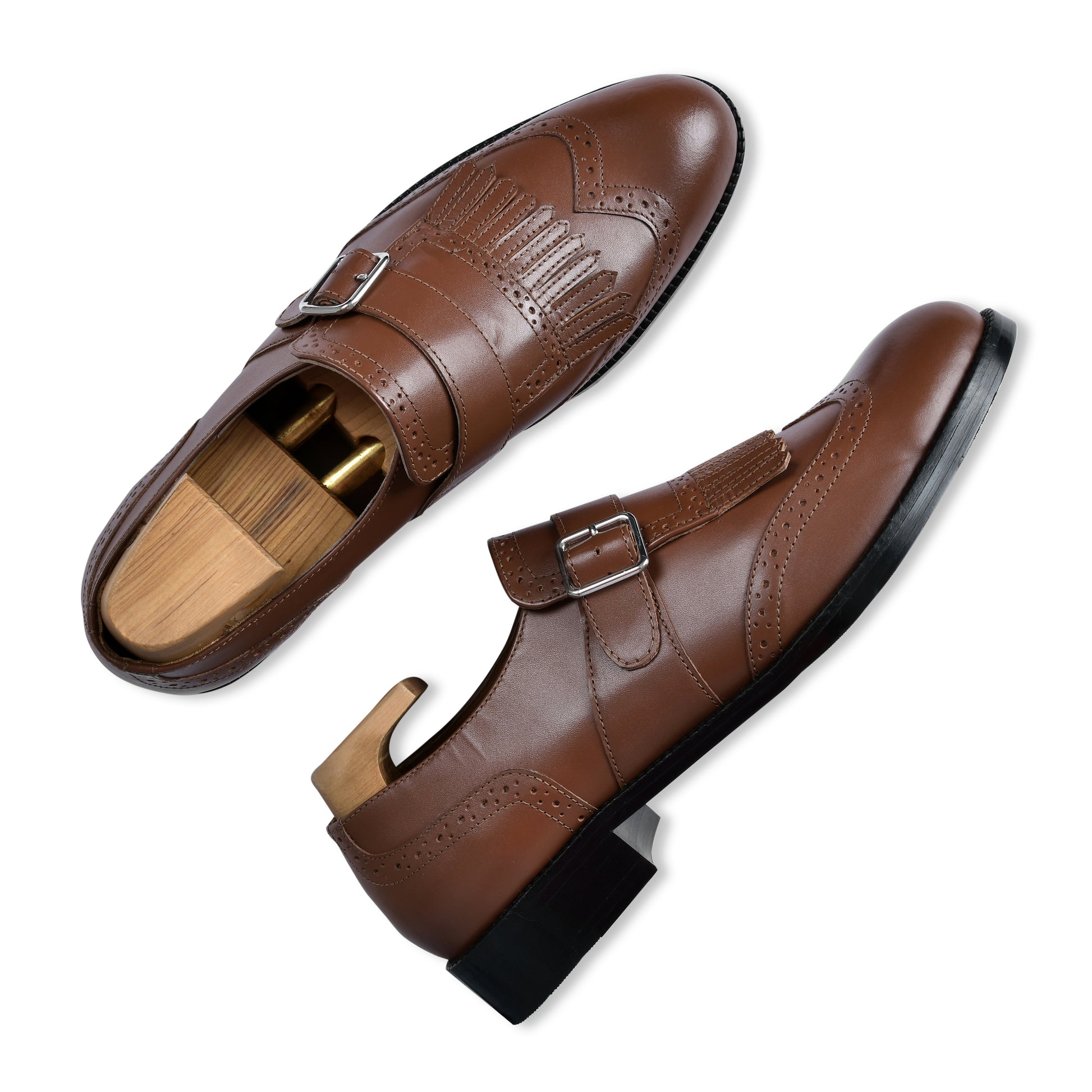 Brown leather shoes with buckles on a white background