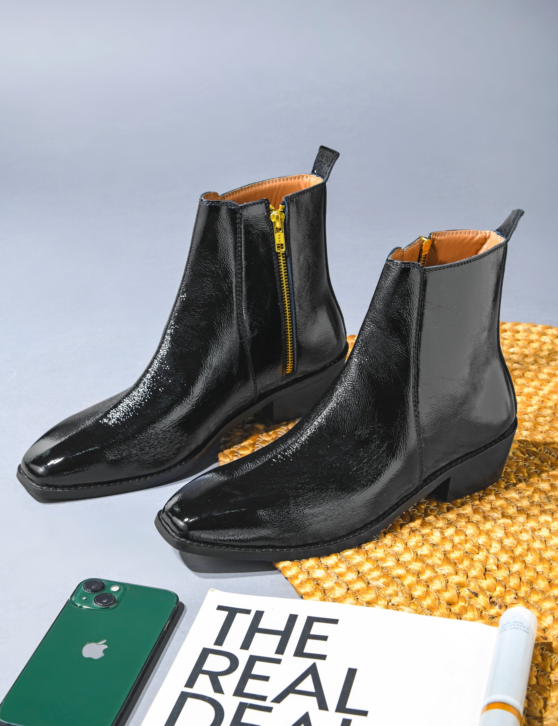 Pair of a Black patent leather boots with side zipper on a Cuban heel