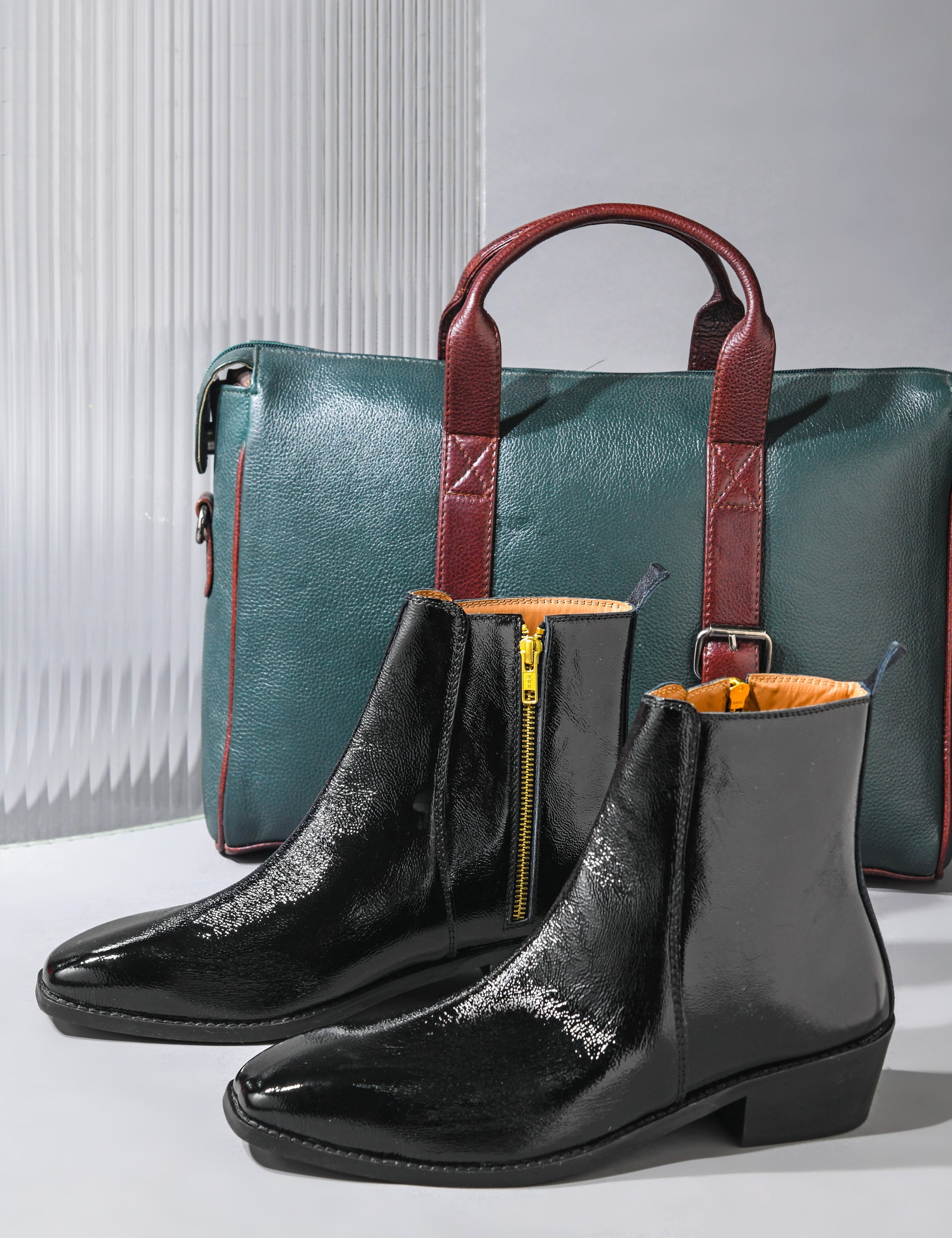 Black patent leather boots on Cuban heel with green leather bag with brown streps