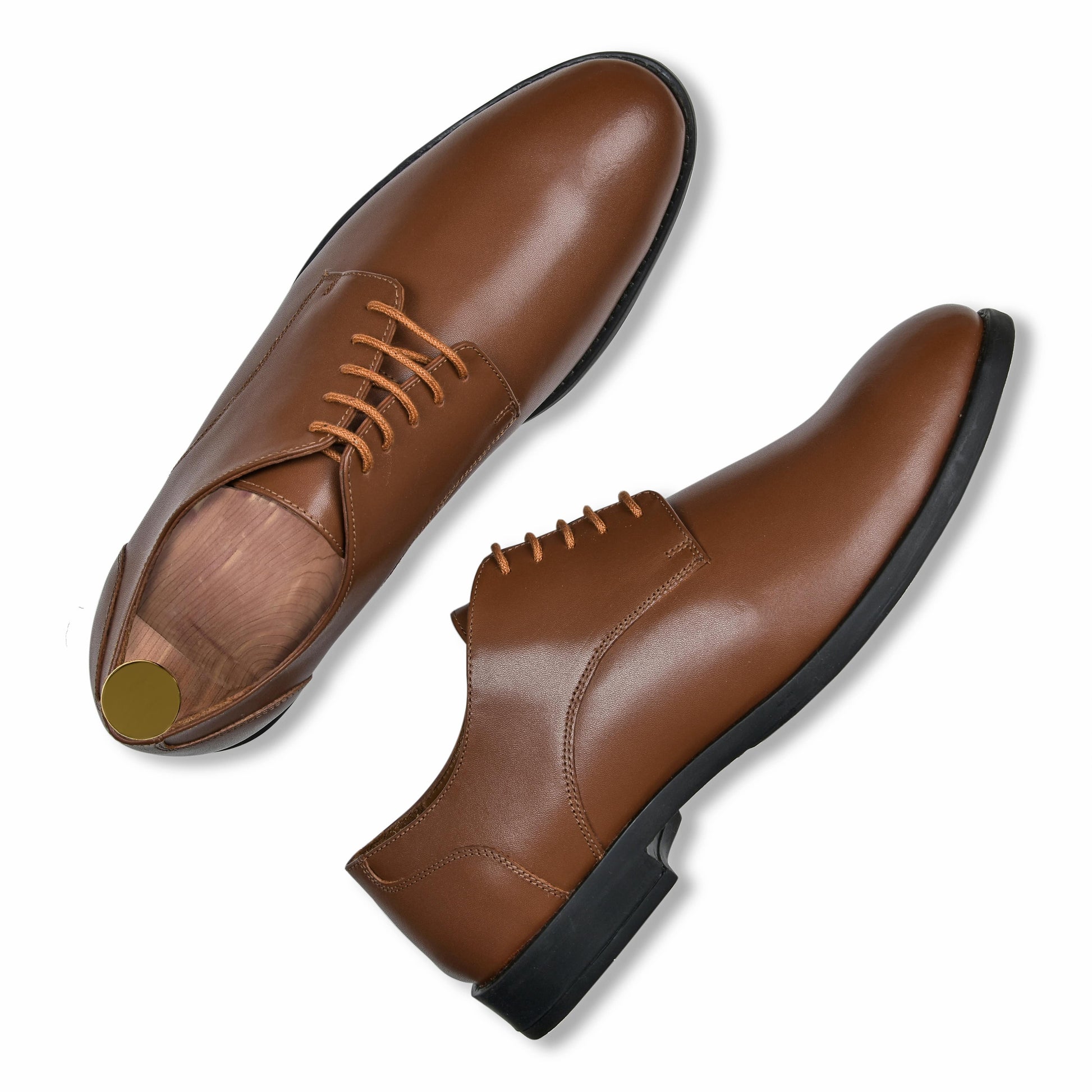 Pair of brown leather dress shoes on a white background