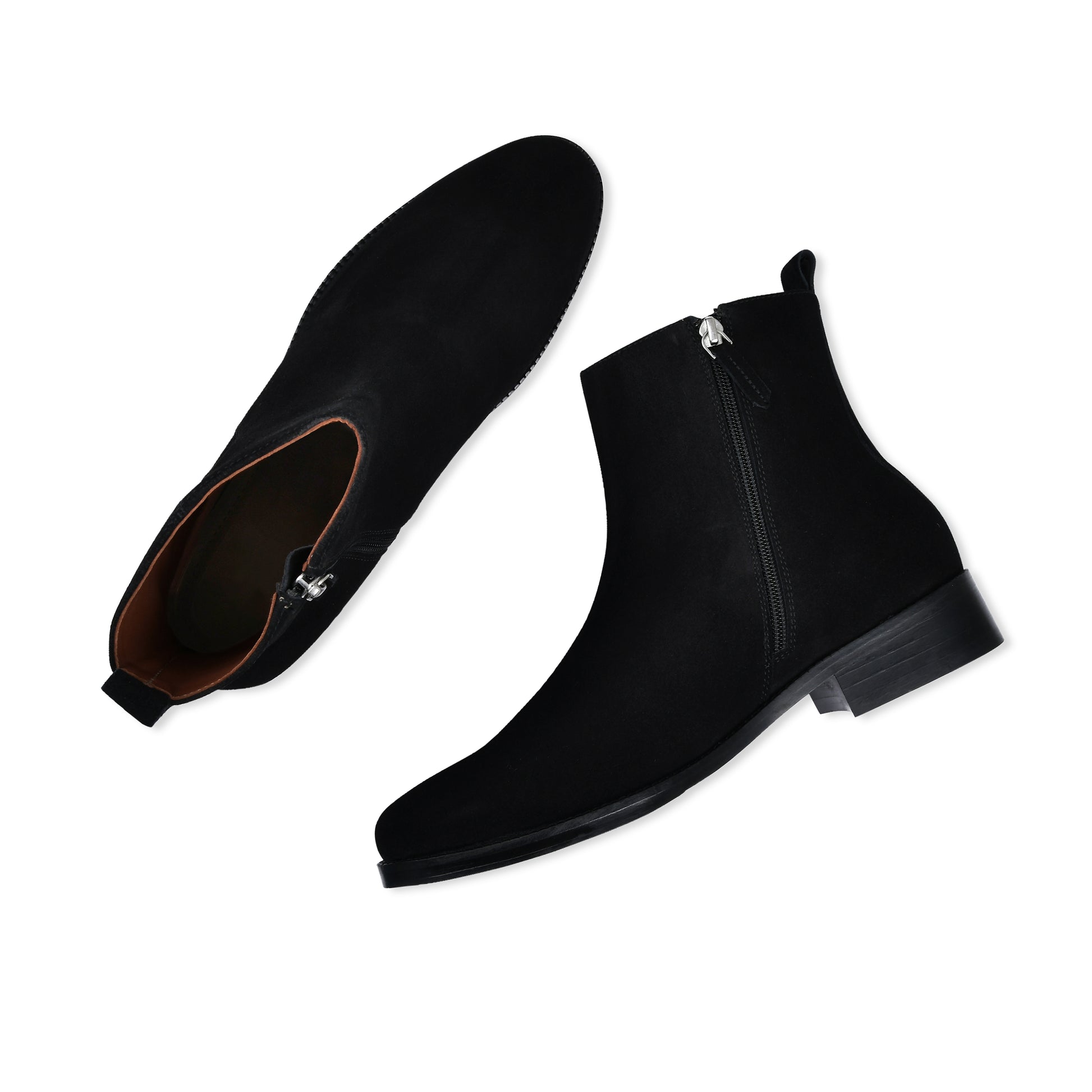 Black Chelsea boots with zippers on a white background