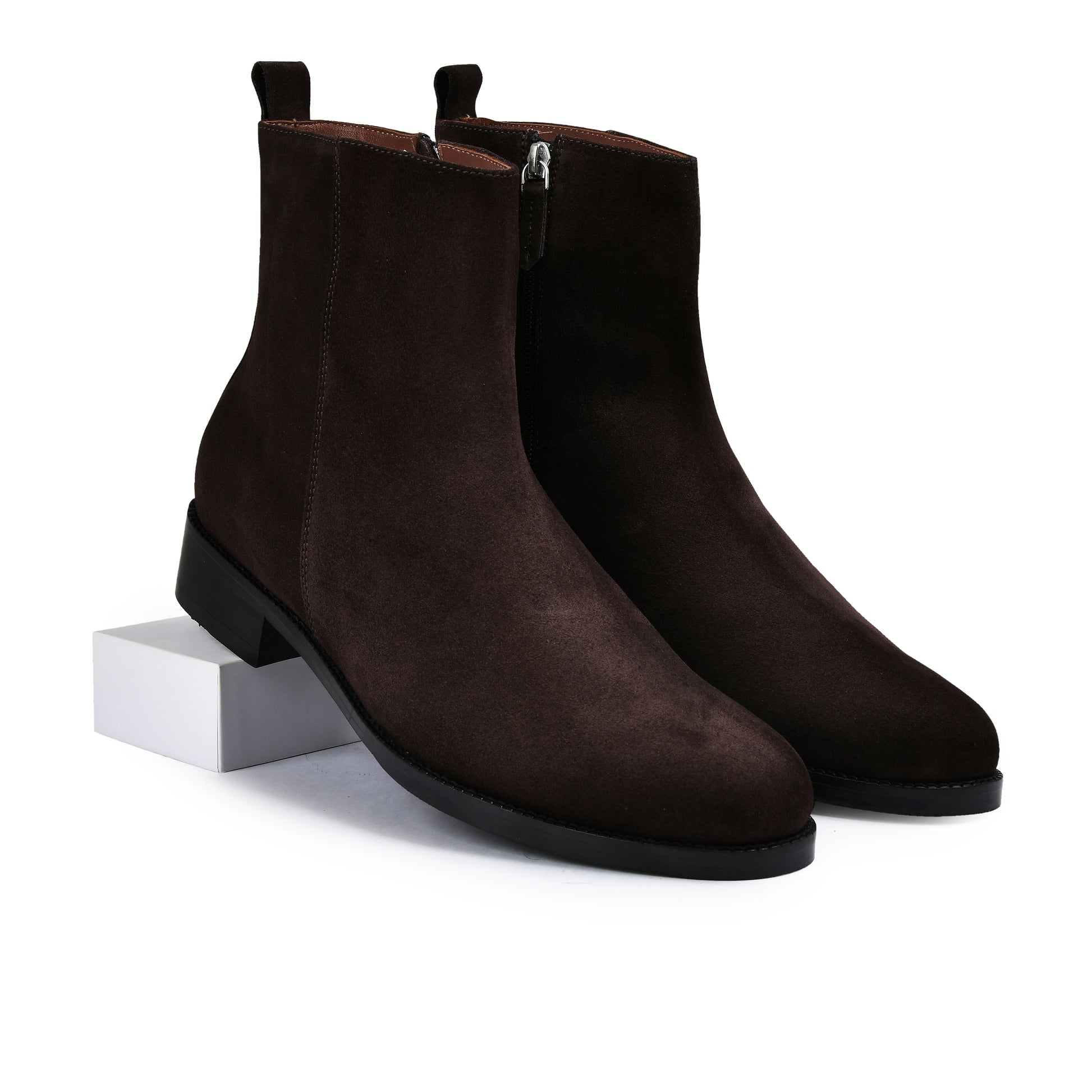 Pair of brown suede ankle boots on a white background