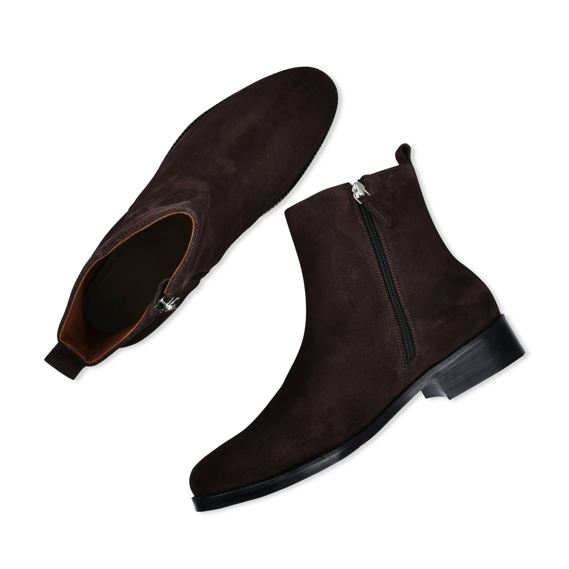 Pair of brown suede boots with zippers on a white background