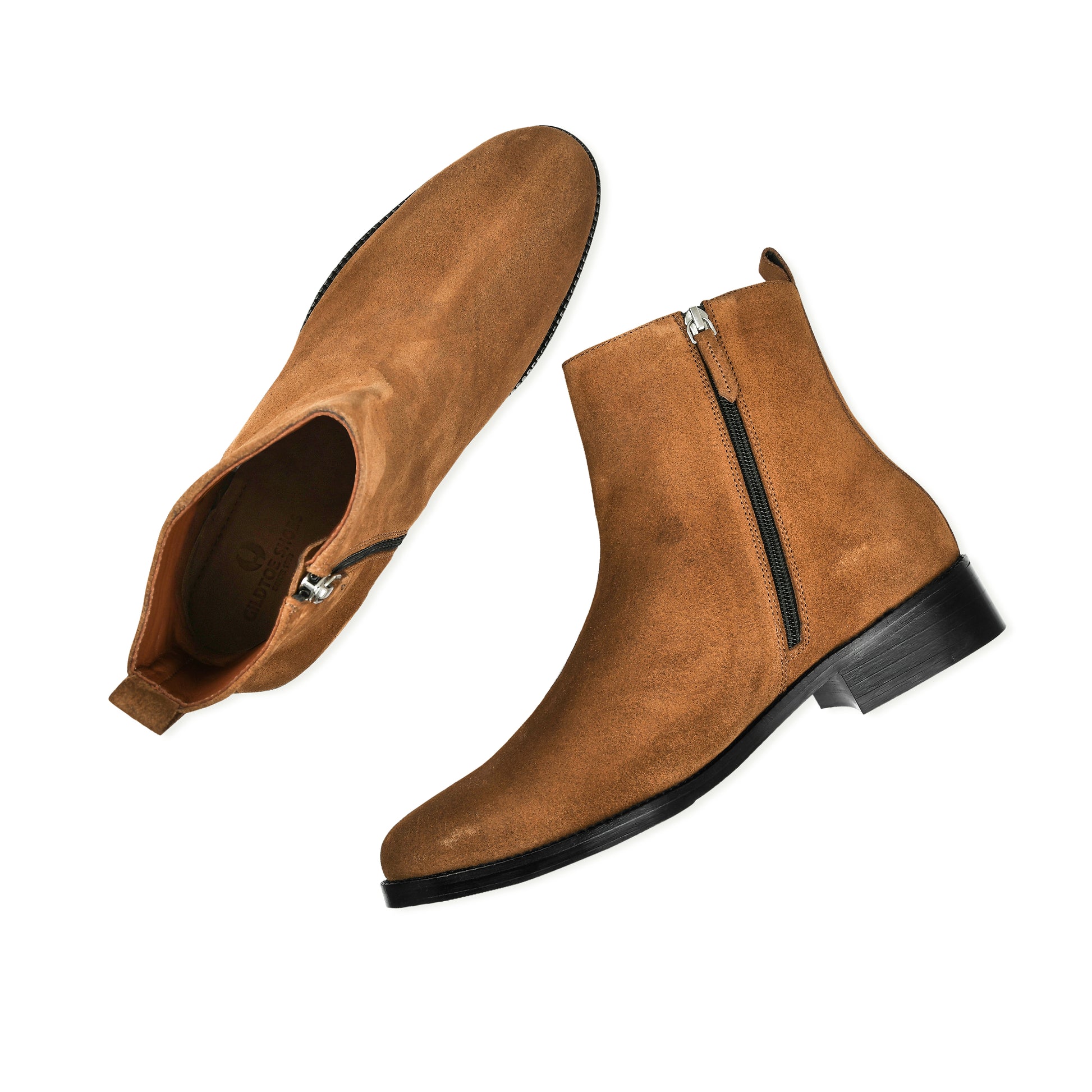 Pair of brown suede ankle boots with zippers on a white background