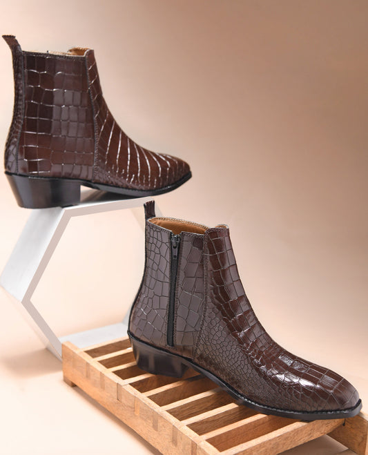 A brown leather side zip boot with a crocodile pattern and a Cuban heel.