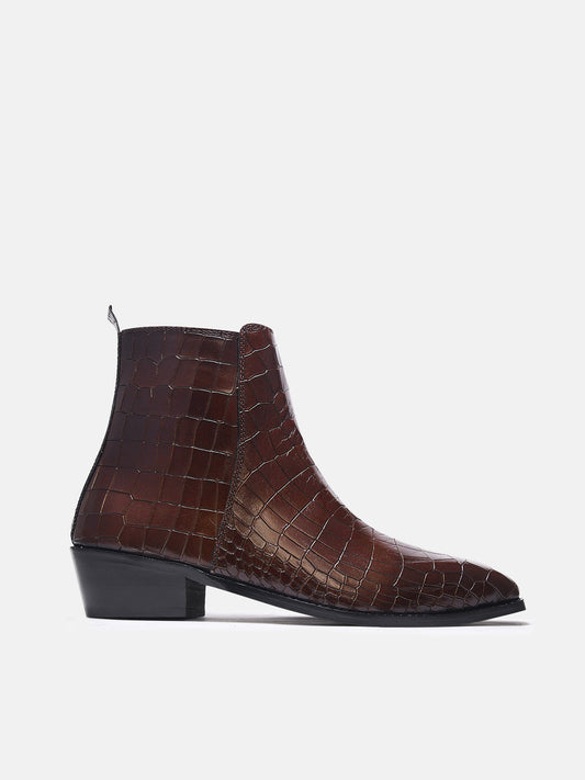 A brown leather side zip boot with a crocodile pattern and a Cuban heel.