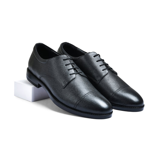 Pair of black leather dress shoes on a white background