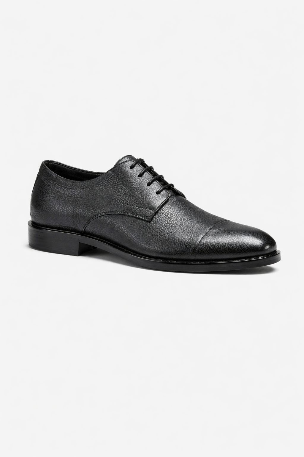 Black leather dress shoe on a white background