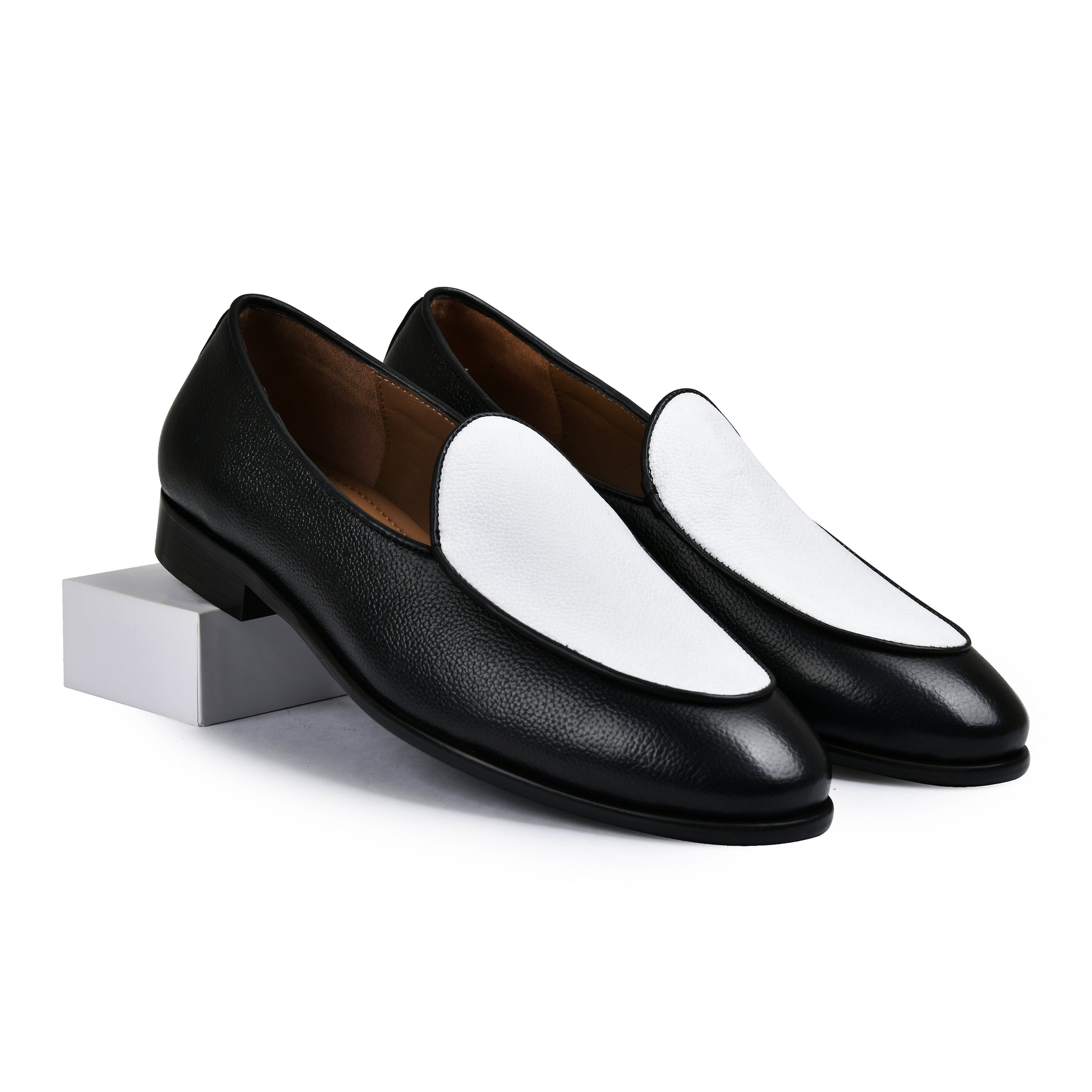 Black and white loafers on a white background