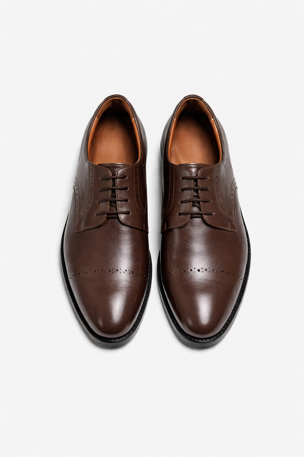Pair of brown leather dress shoes on a white background