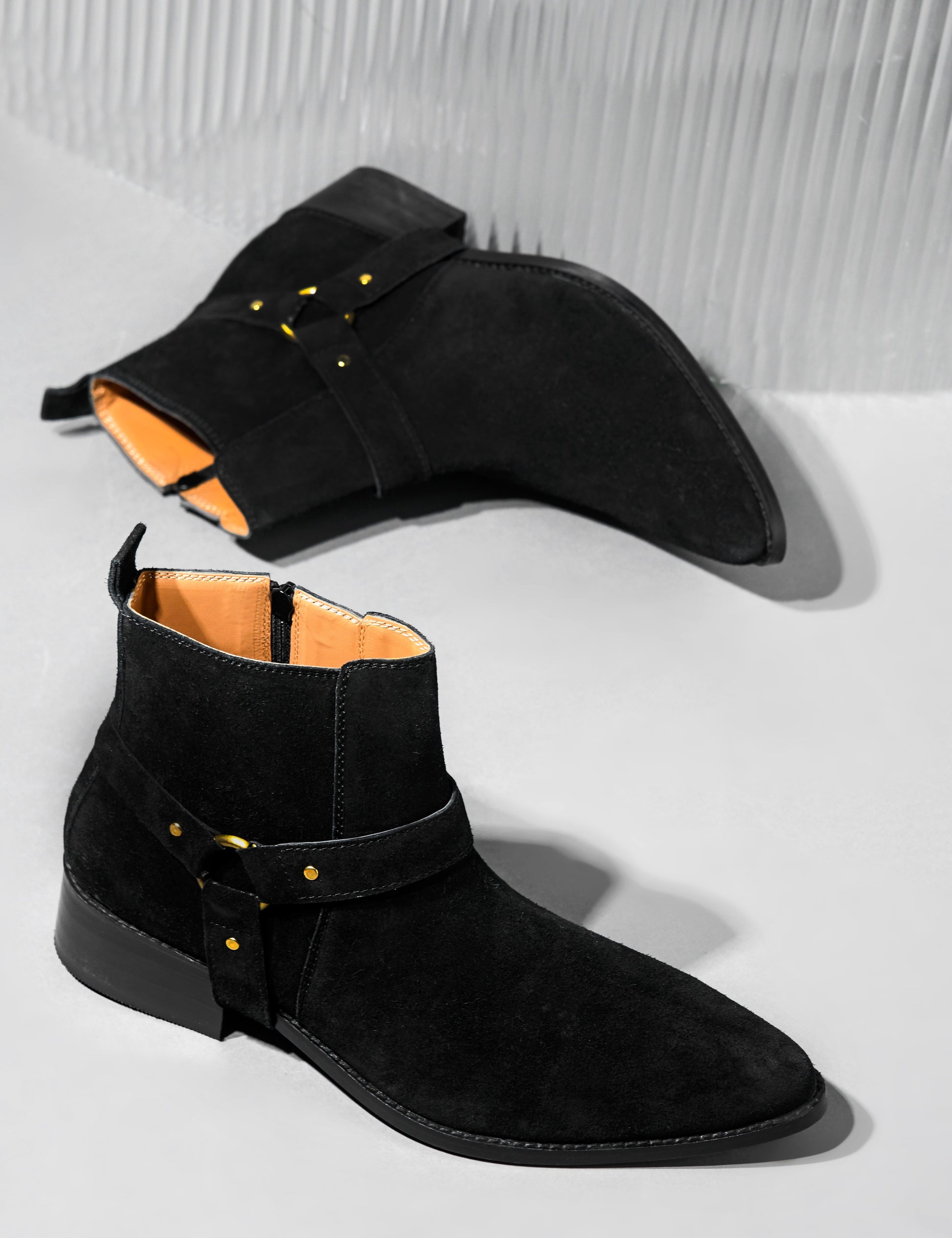 Phantom black suede harness boots for men featuring a pointed toe, side zip closure, and attached leather thong strap – luxury ankle boots by RNK Luxe for bold, stylish looks.