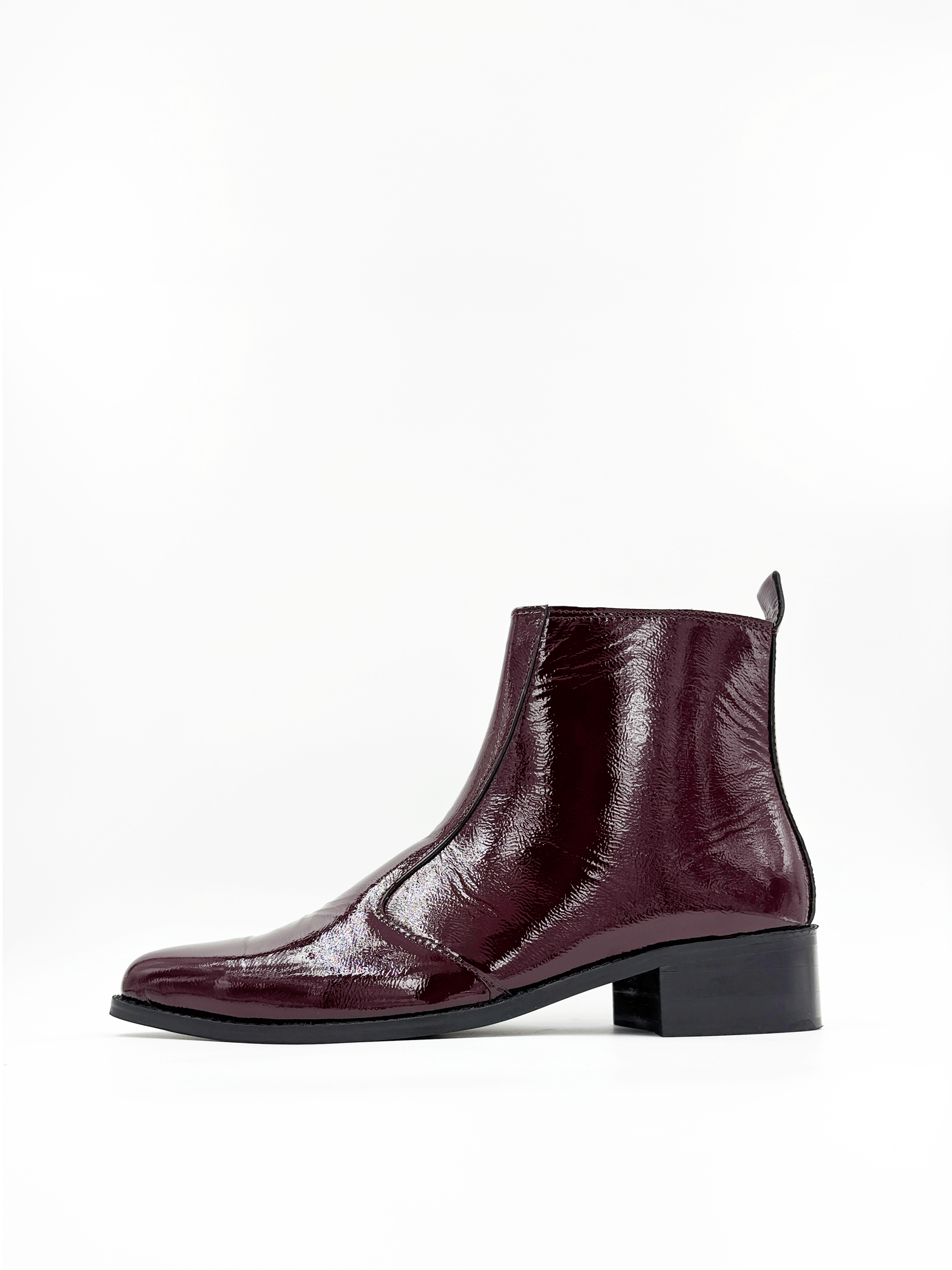 Men’s cherry red pointed-toe Chelsea boots in glossy patent leather with side zip closure, sleek and stylish luxury footwear ideal for formal and party outfits.