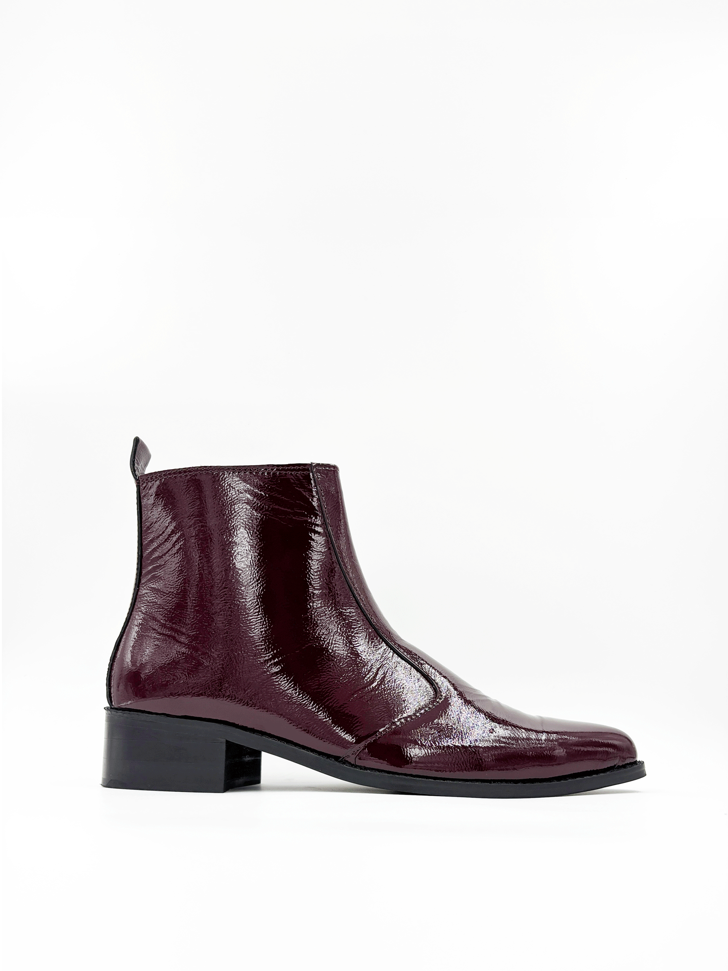 Men’s cherry red pointed-toe Chelsea boots in glossy patent leather with side zip closure, sleek and stylish luxury footwear ideal for formal and party outfits.