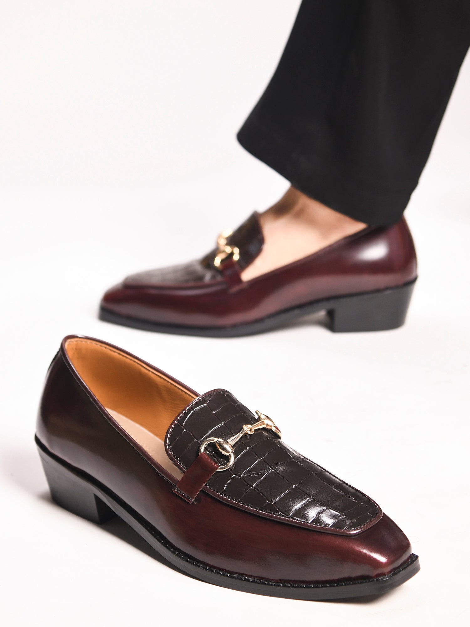 A pair of cherry leather loafer in which it embossed with brown croco leather on top with a golder horesit buckle