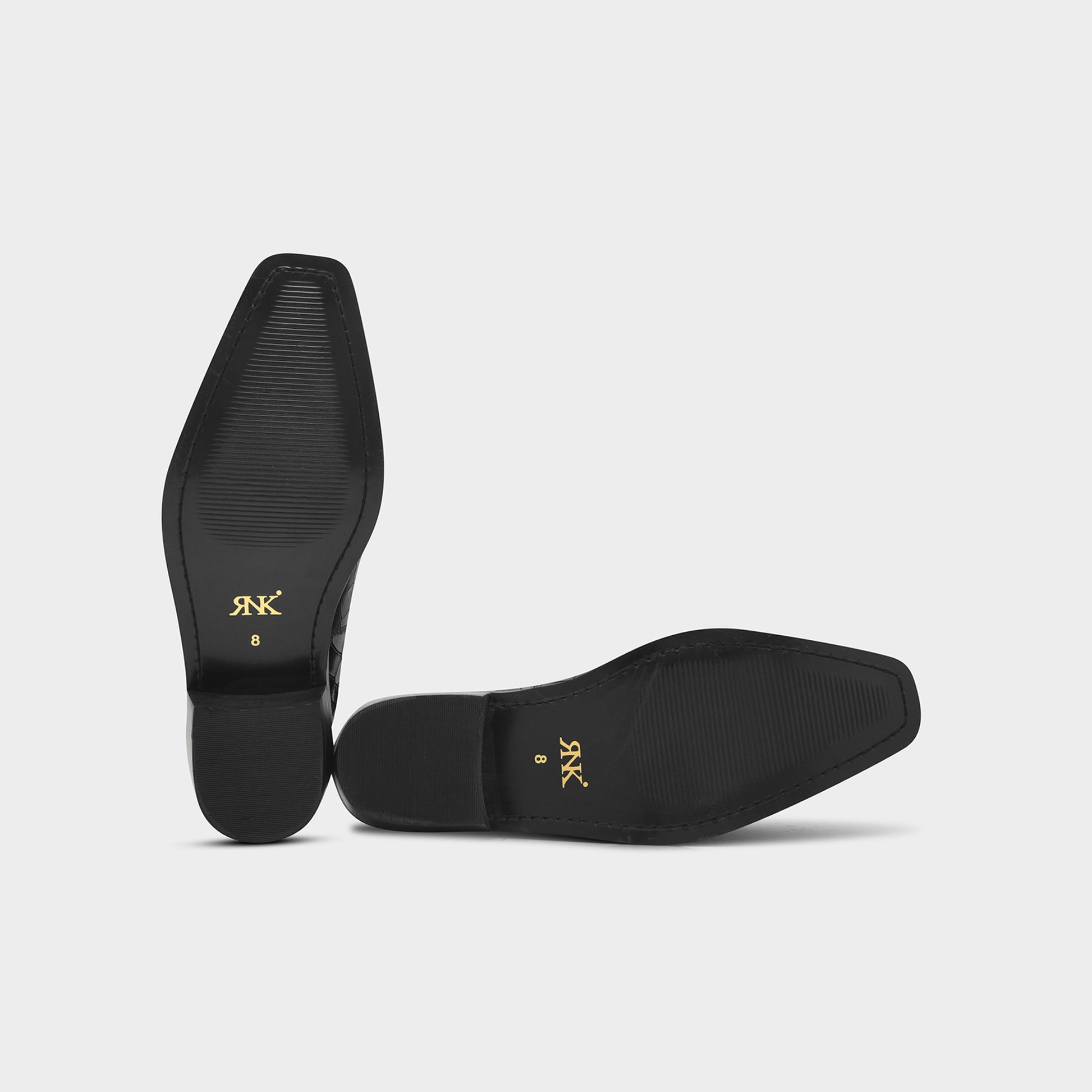 Black shoes with gold logo on a light gray background