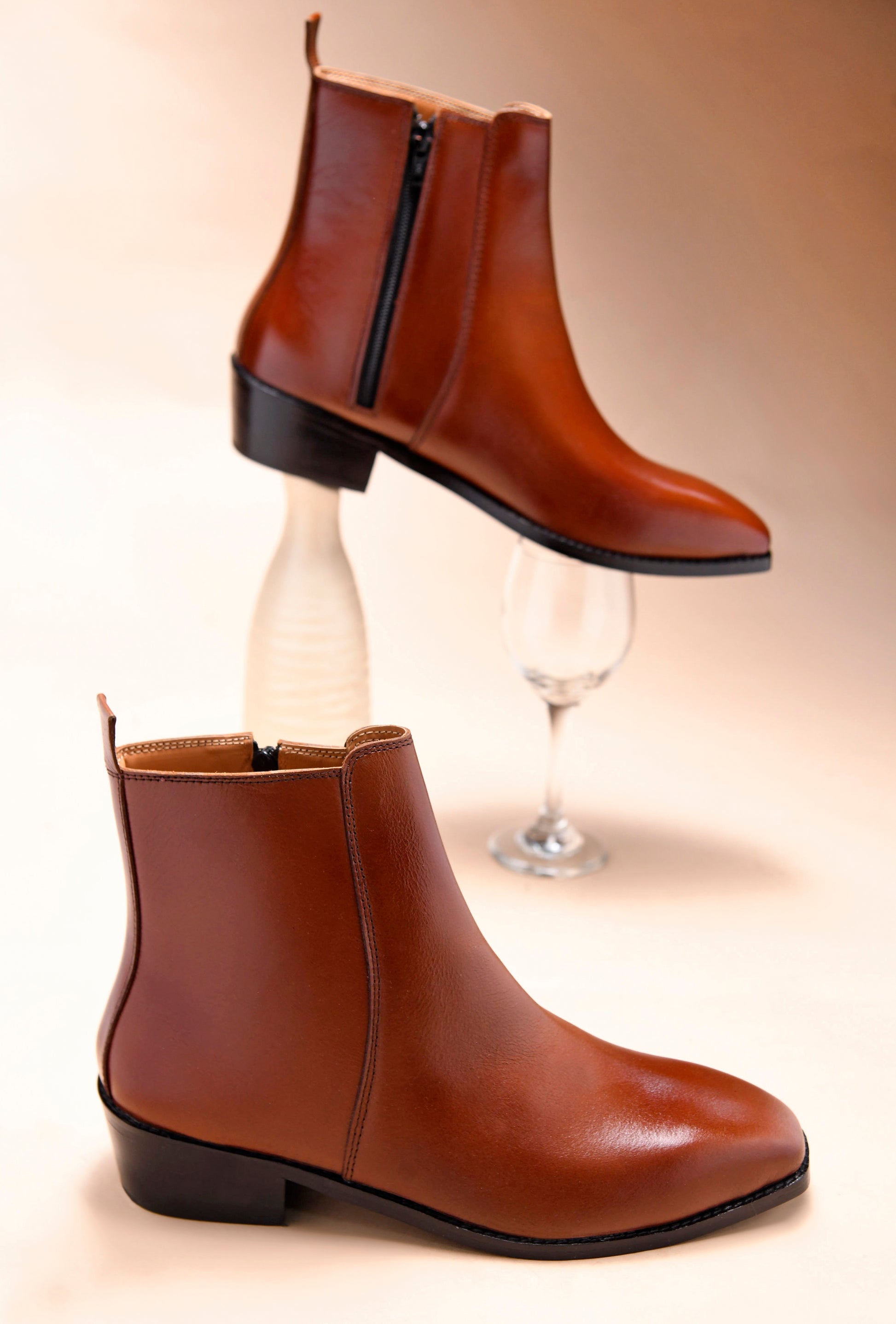A men's side zip leather boot with a tan finish and a cuban heel.