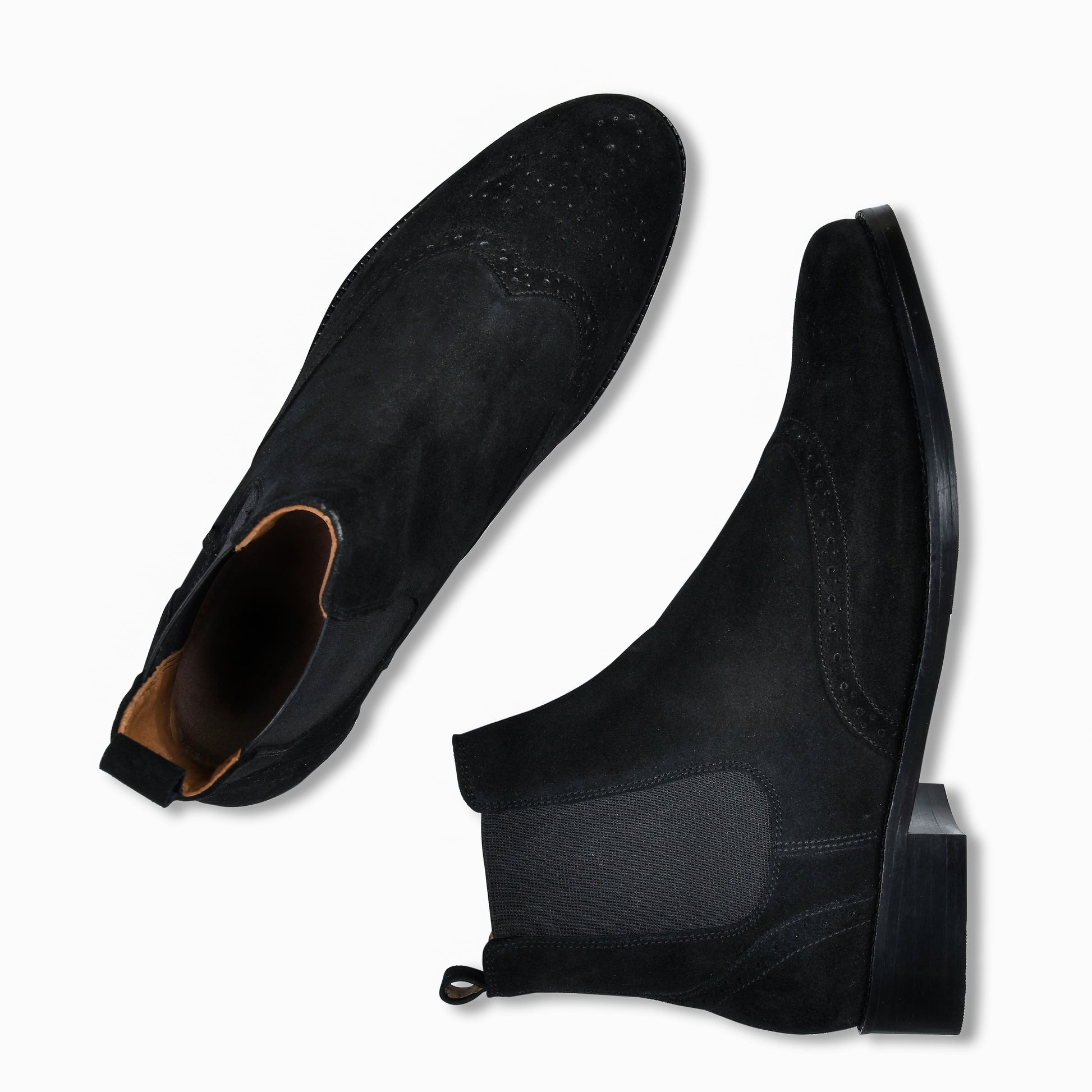 Black suede Chelsea boots on a white background