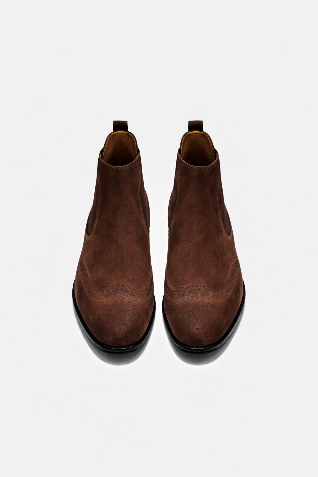 Pair of brown leather boots on a white background