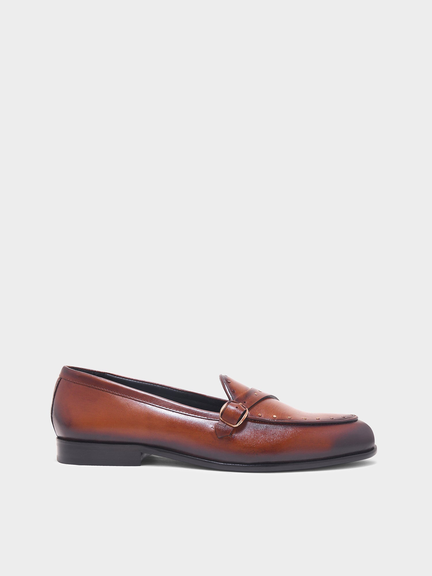 Brown leather loafer on a light gray background